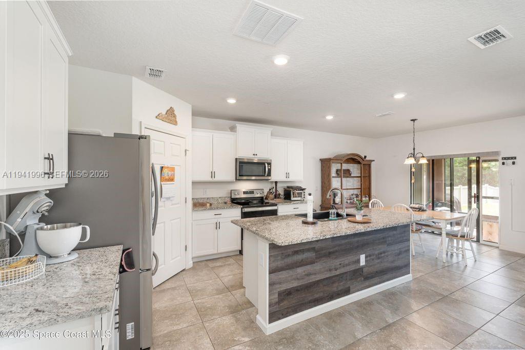 a kitchen with a sink appliances and cabinets