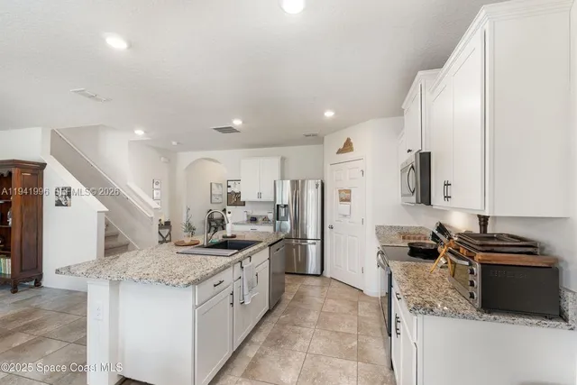 a kitchen with a sink stove and refrigerator