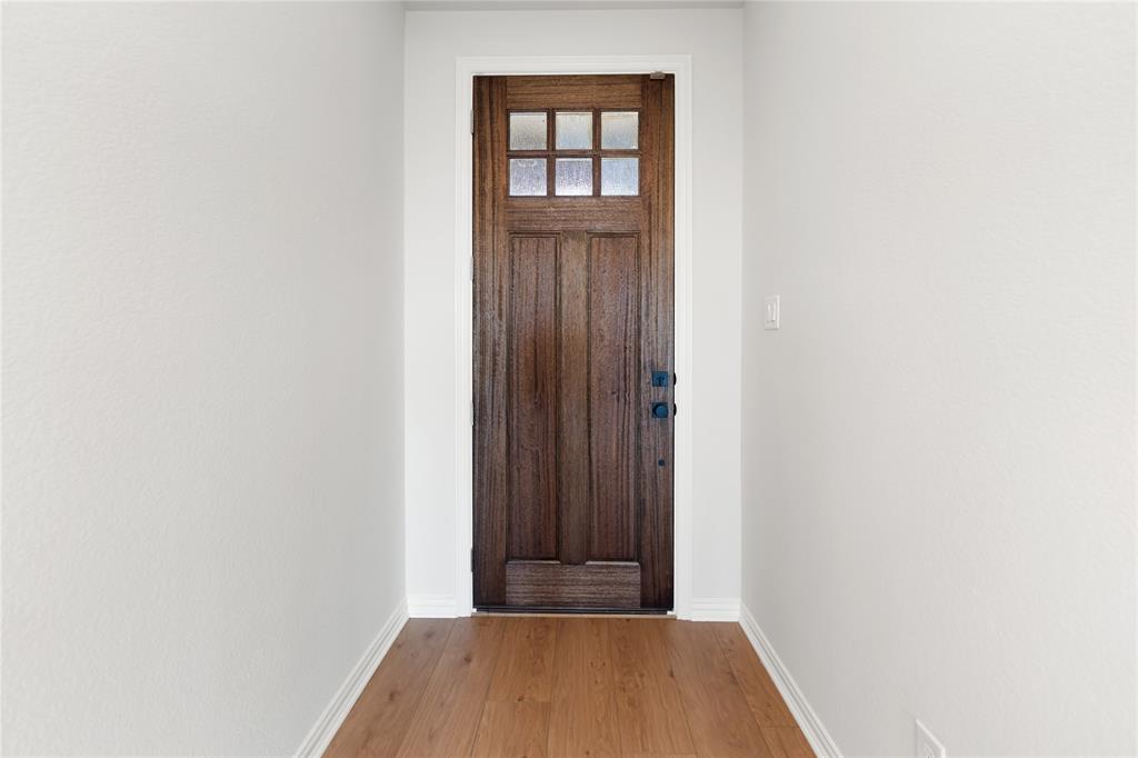 30 Roosevelt Ln Valley View Valley View, TX 76272 - Photo 8 of 35 a view of a hallway with wooden floor