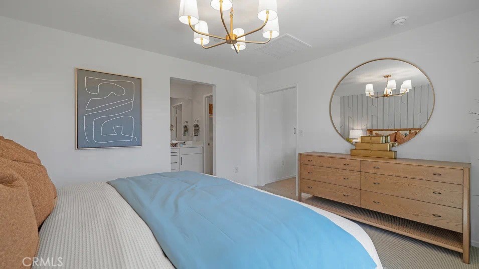 79327 Valor Lane Indio, CA 92203 - Photo 12 of 19 a bedroom with a bed and a mirror on the dresser
