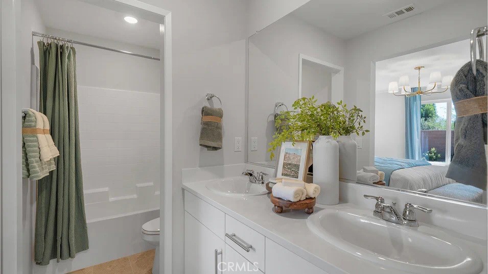 79327 Valor Lane Indio, CA 92203 - Photo 13 of 19 a bathroom with double vanity sink a mirror and a shower