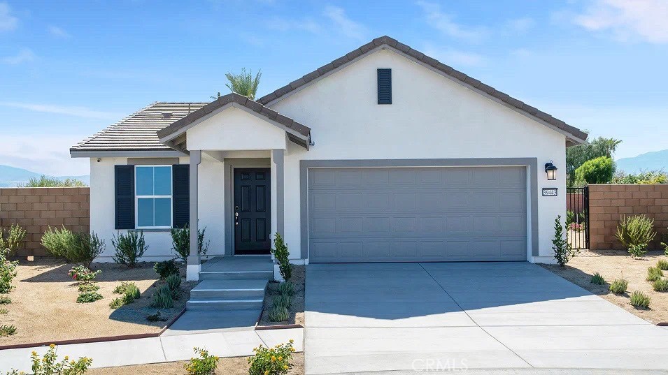 79327 Valor Lane Indio, CA 92203 - Photo 16 of 19 a front view of a house with garage
