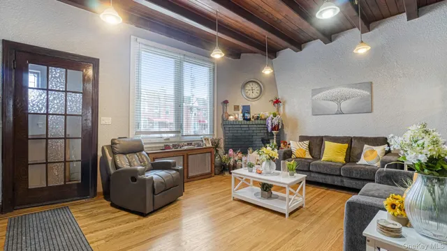 a view of a livingroom with workspace and a window