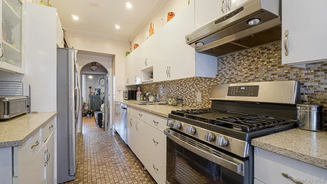 a kitchen with a sink and a refrigerator