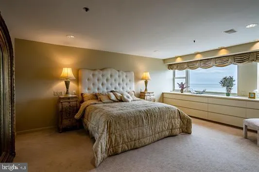 a bed room with a bed and a large window