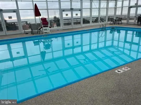a living room with furniture and floor to ceiling window