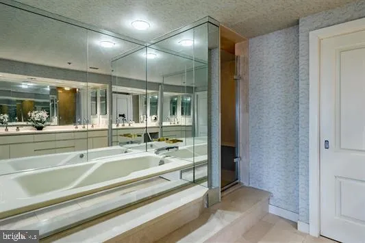 a spacious bathroom with a mirror and shower