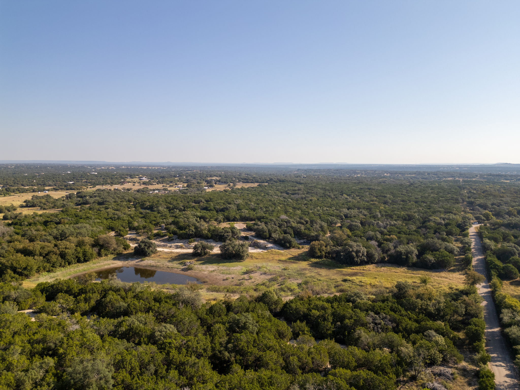 112 Loop 308 Briggs, TX 78608 - Photo 29 of 37 Aerial view of a heavily wooded area and a large body of water