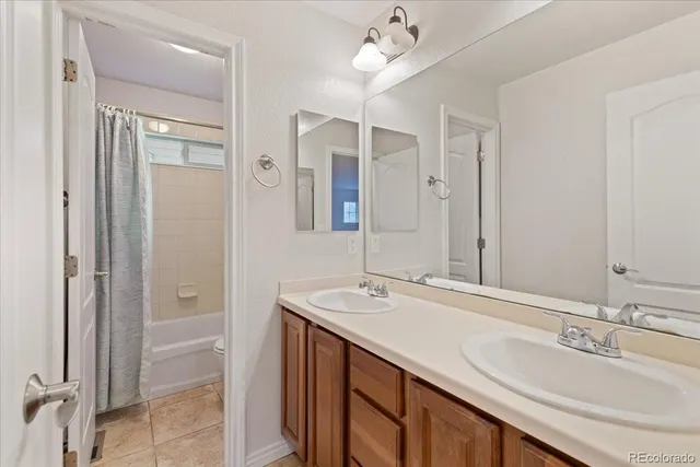a bathroom with a sink double vanity and a mirror