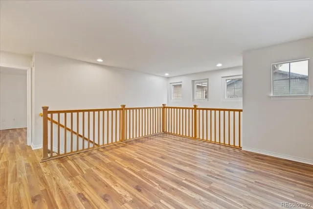 a view of a hallway with wooden floor