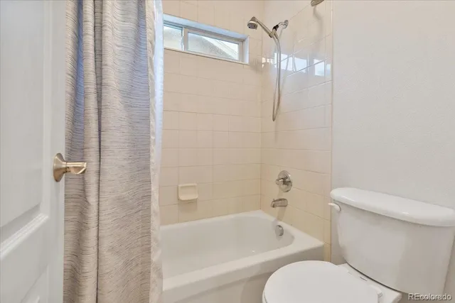 a bathroom with a toilet and a bathtub