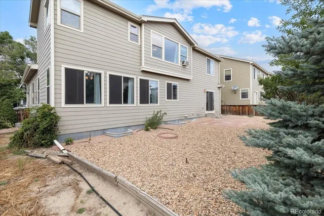 a front view of house with yard and trees around