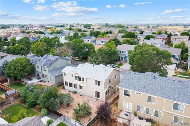 an aerial view of residential houses with outdoor space and ocean view
