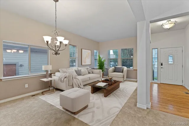 a living room with fireplace furniture and a chandelier