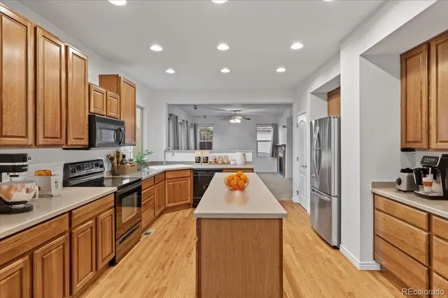 a kitchen with stainless steel appliances granite countertop refrigerator a sink dishwasher stove and oven