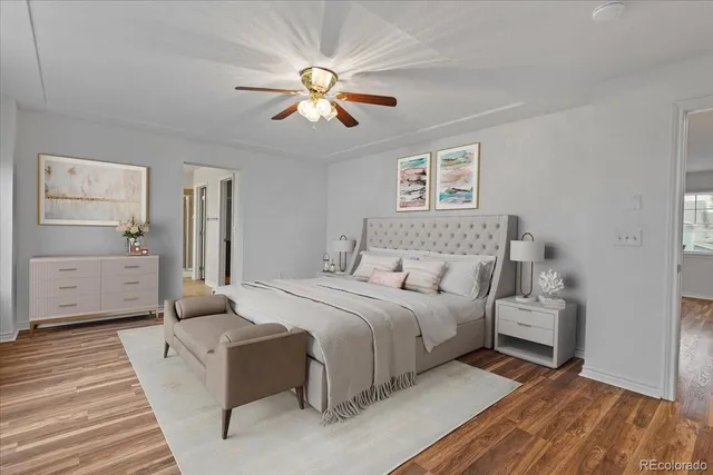 a bedroom with a large bed and a chandelier