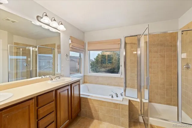 a bathroom with a tub sink and a shower