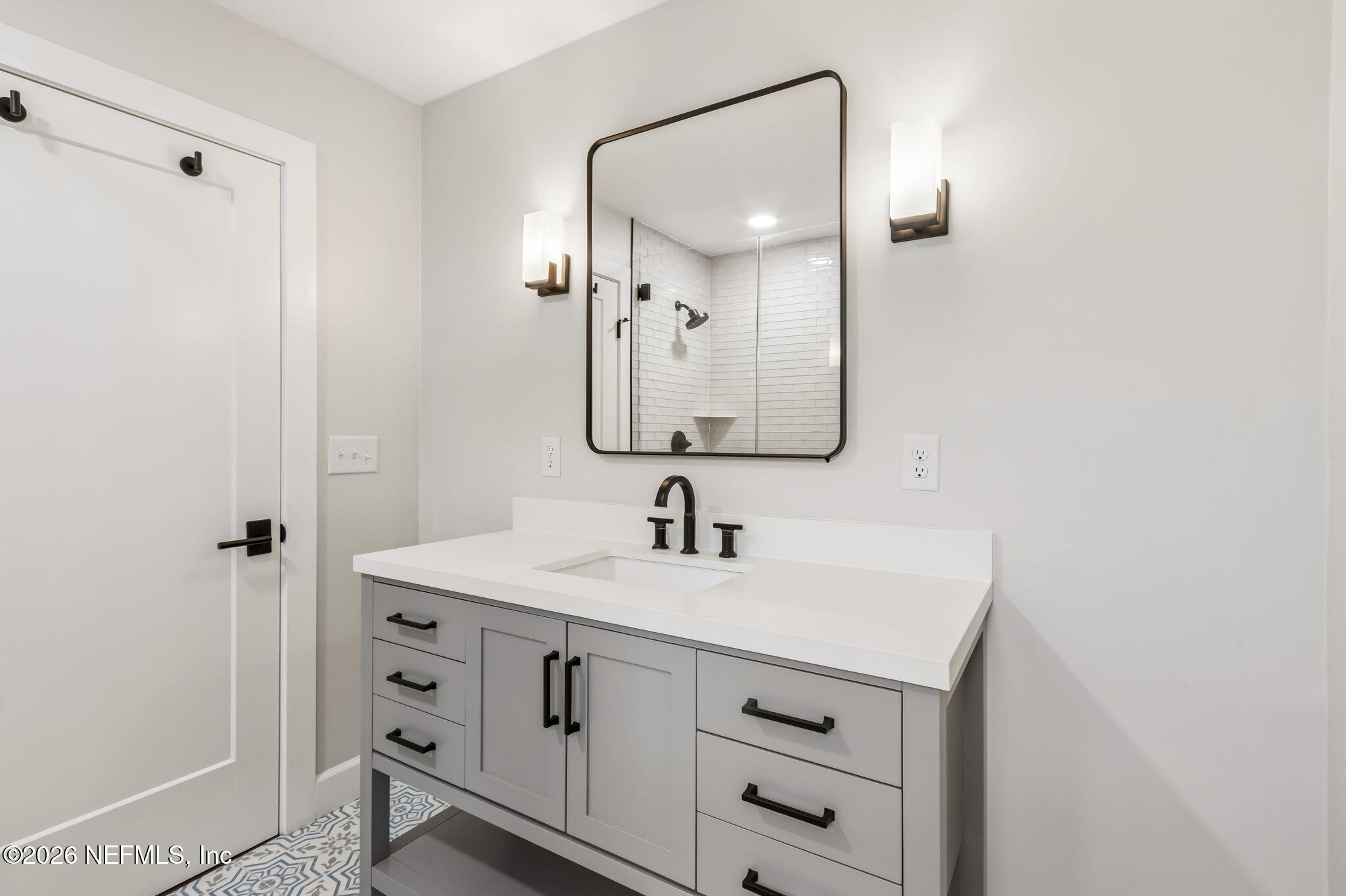 1877 Christopher Point Road South Jacksonville, FL 32217 - Photo 14 of 27 a bathroom with a sink a vanity and a mirror