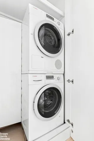 a bathroom with a toilet a sink a mirror and vanity