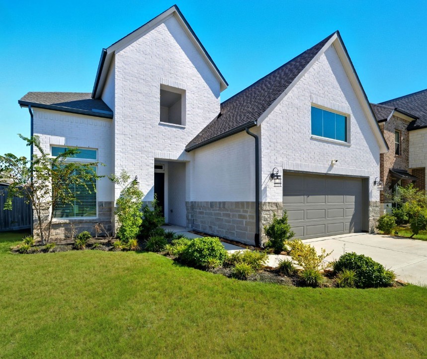 10438 Rigel Rdg Way Richmond, TX 77406 - Photo 2 of 34 a front view of a house with a yard and garage