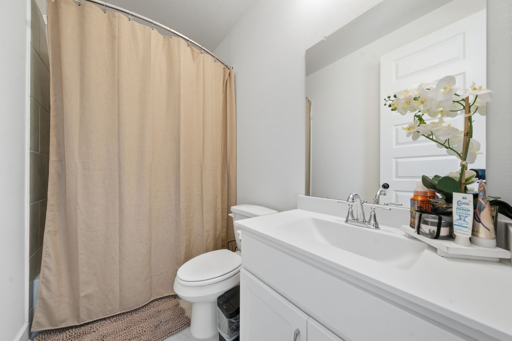 10438 Rigel Rdg Way Richmond, TX 77406 - Photo 24 of 34 a bathroom with a sink a toilet and a mirror