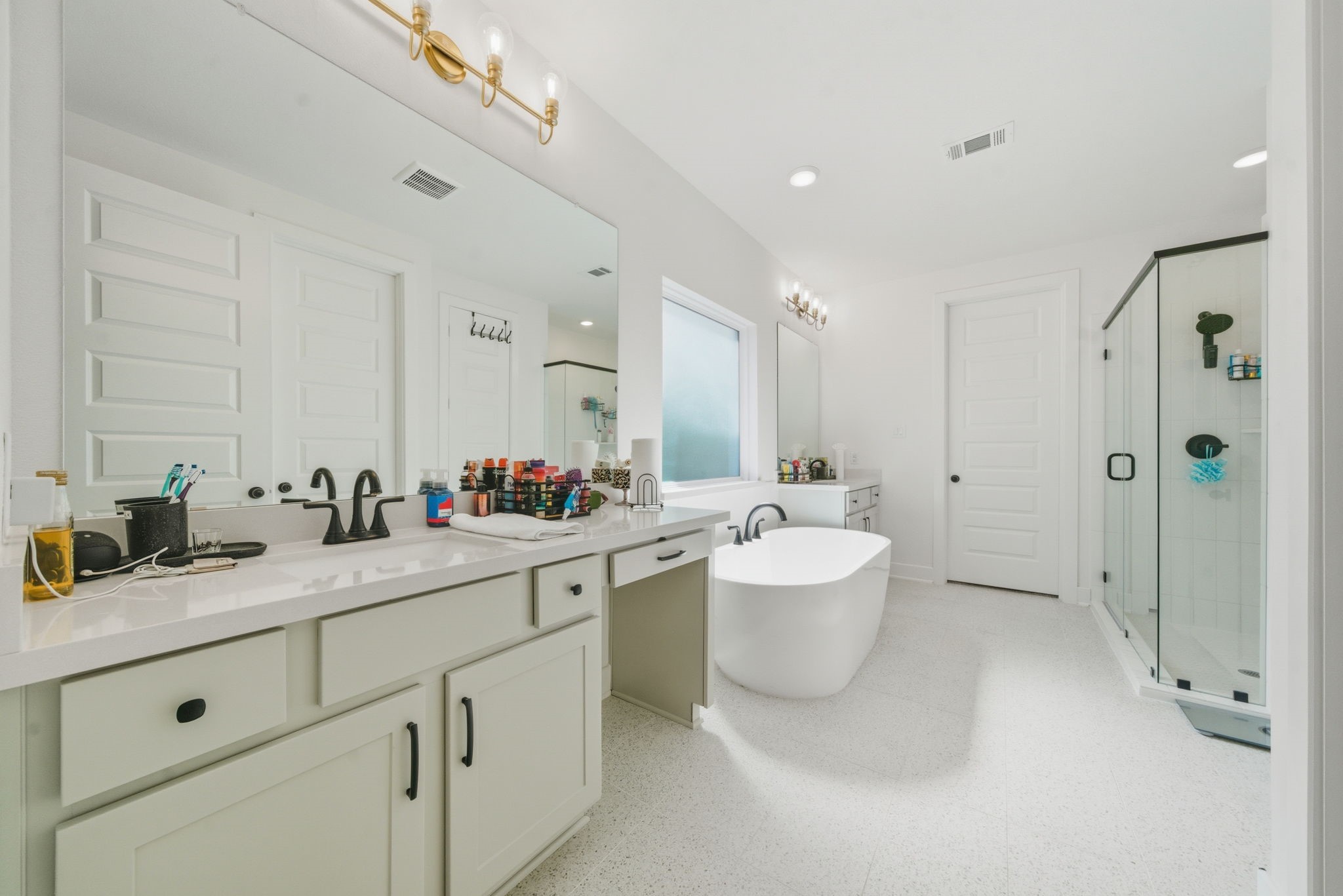 10438 Rigel Rdg Way Richmond, TX 77406 - Photo 26 of 34 a bathroom with a double vanity sink toilet mirror and bathtub