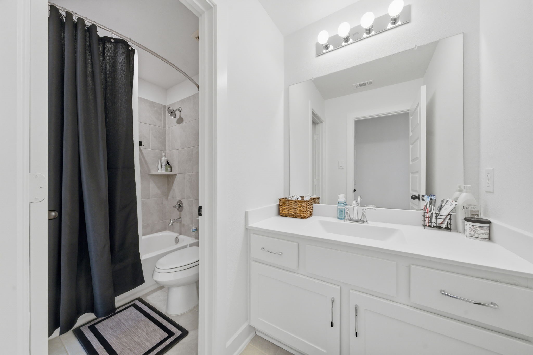 10438 Rigel Rdg Way Richmond, TX 77406 - Photo 29 of 34 a en suite bathroom with a toilet sink double vanity and mirror