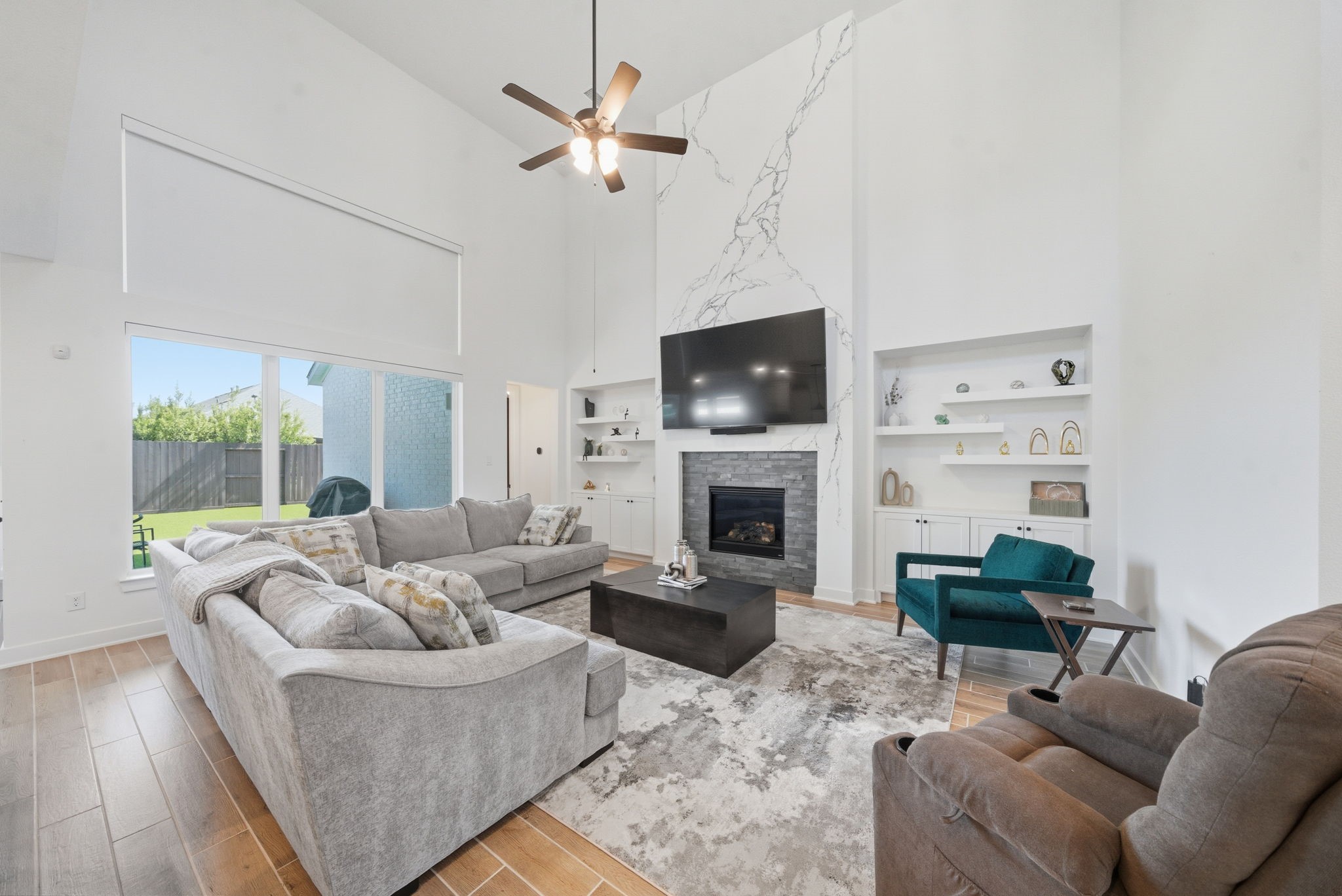 10438 Rigel Rdg Way Richmond, TX 77406 - Photo 6 of 34 a living room with furniture a fireplace and a flat screen tv