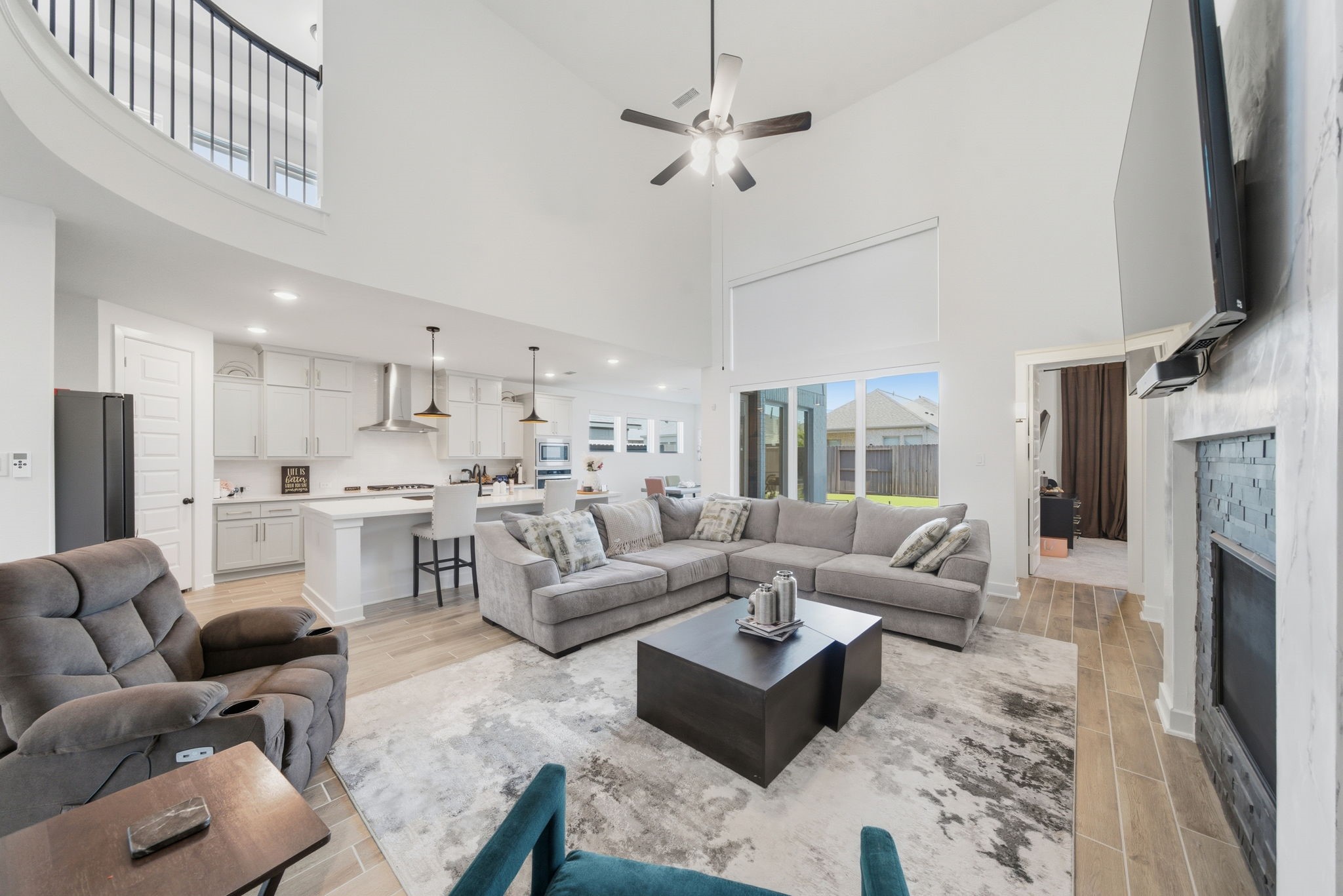 10438 Rigel Rdg Way Richmond, TX 77406 - Photo 7 of 34 a living room with furniture a fireplace and a flat screen tv