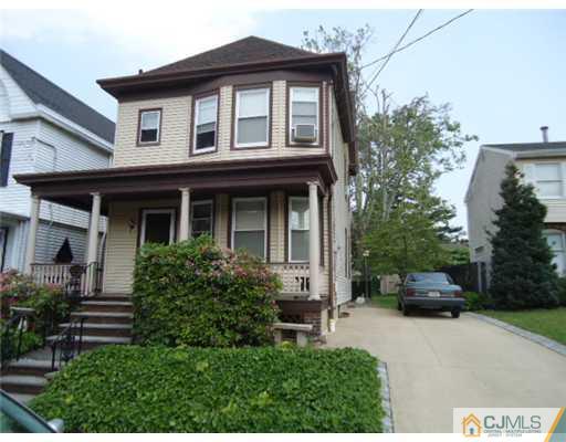 242 Rector Street Perth Amboy, NJ 08861 - Photo 1 of 18 a front view of a house with a garden