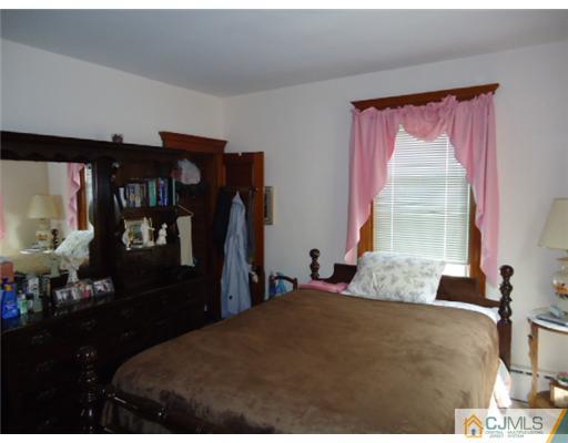 242 Rector Street Perth Amboy, NJ 08861 - Photo 11 of 18 a bedroom with a bed and window