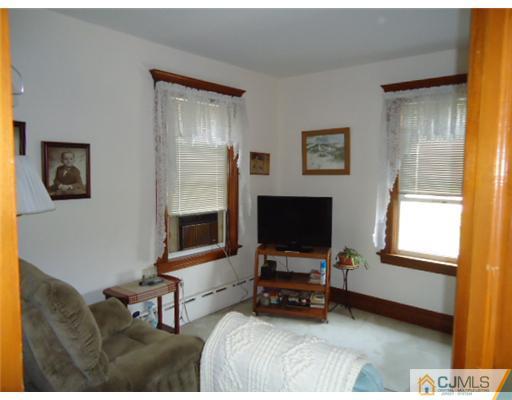 242 Rector Street Perth Amboy, NJ 08861 - Photo 13 of 18 a living room with furniture and a flat screen tv with wooden floor