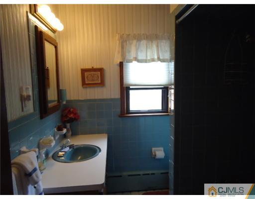 242 Rector Street Perth Amboy, NJ 08861 - Photo 14 of 18 a bathroom with a sink and a mirror
