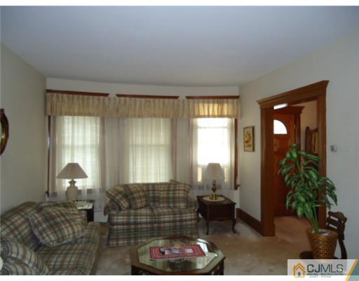 242 Rector Street Perth Amboy, NJ 08861 - Photo 3 of 18 a bedroom with furniture and a window