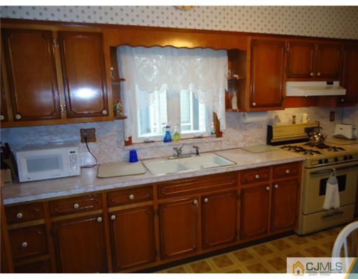 242 Rector Street Perth Amboy, NJ 08861 - Photo 6 of 18 a kitchen with stainless steel appliances granite countertop a sink and cabinets