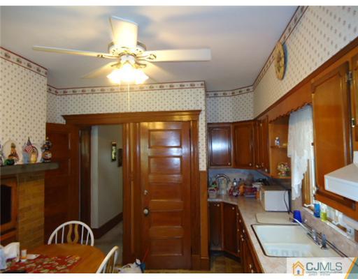 242 Rector Street Perth Amboy, NJ 08861 - Photo 7 of 18 a bathroom with a sink a light fixture and a mirror