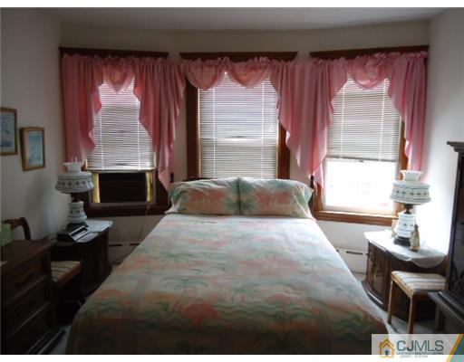 242 Rector Street Perth Amboy, NJ 08861 - Photo 9 of 18 a bedroom with a bed and a window