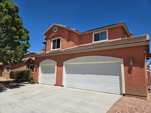 a front view of a house with garage