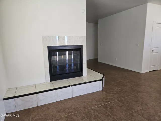 a living room with a table and a fireplace