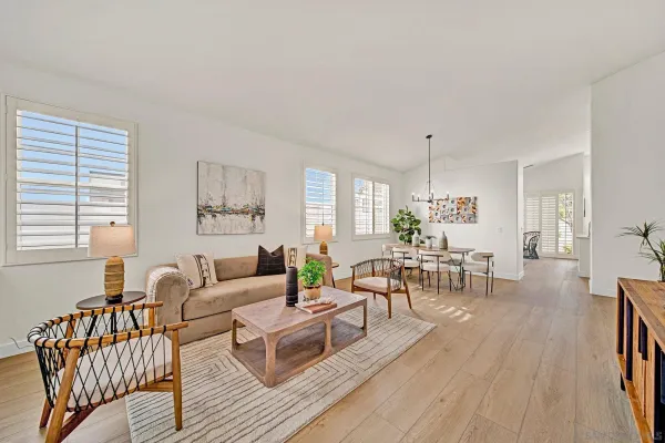 a living room with furniture wooden floor and a window