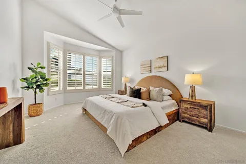 a bedroom with a bed and a lamp