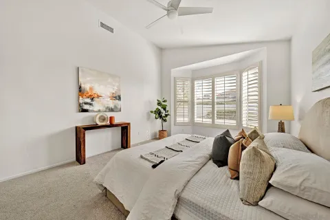 a bedroom with a bed and a potted plant