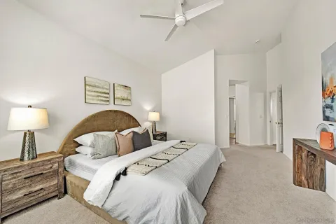 a bedroom with a large bed and a chandelier