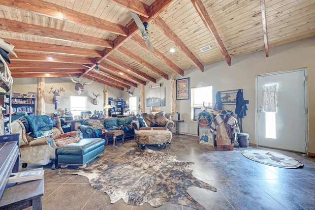 a living room with lots of furniture and gym equipment