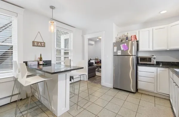 a kitchen with refrigerator and cabinets