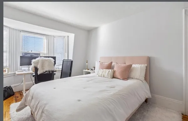 a bedroom with a bed and a large mirror