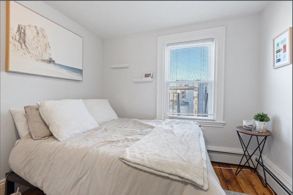 16 Atlantic Street Boston, MA 02127 - Photo 14 of 18 a bedroom with a bed and a window