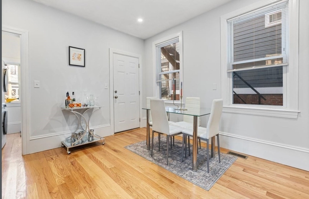 16 Atlantic Street Boston, MA 02127 - Photo 17 of 18 a dining room with wooden floor and a table