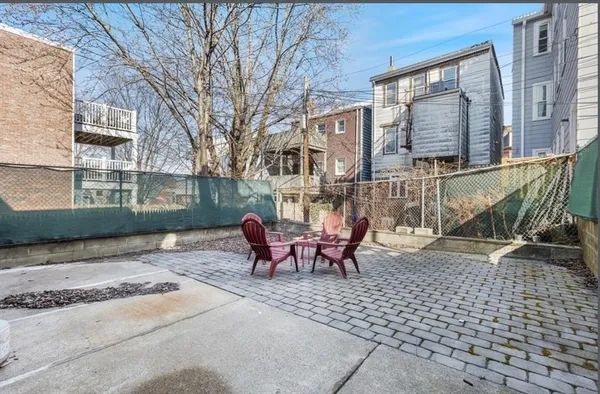 a view of a brick building with a bench in the patio