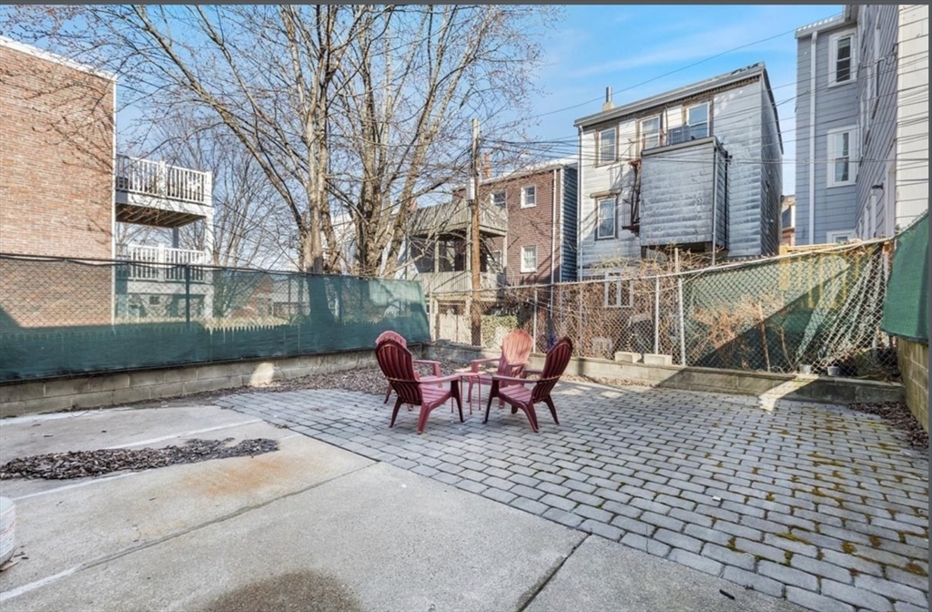 16 Atlantic Street Boston, MA 02127 - Photo 18 of 18 a view of a brick building with a bench in the patio